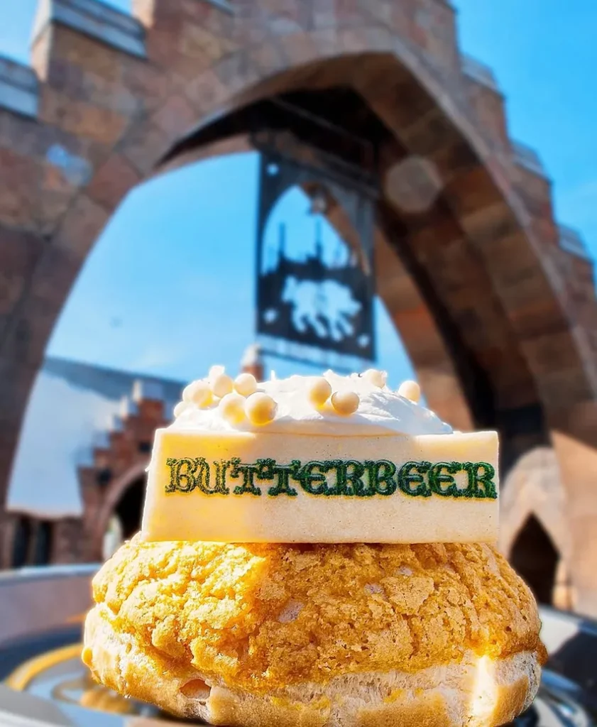 Cookie made with butterbeer in front of the Hogsmeade portal at Universal's Island of Adventure park Orlando