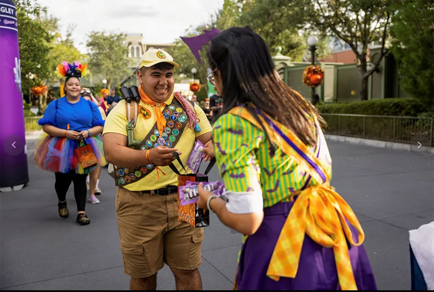 Visitors receive candy during the Halloween party at the Magic Kingdom of Walt Disney World