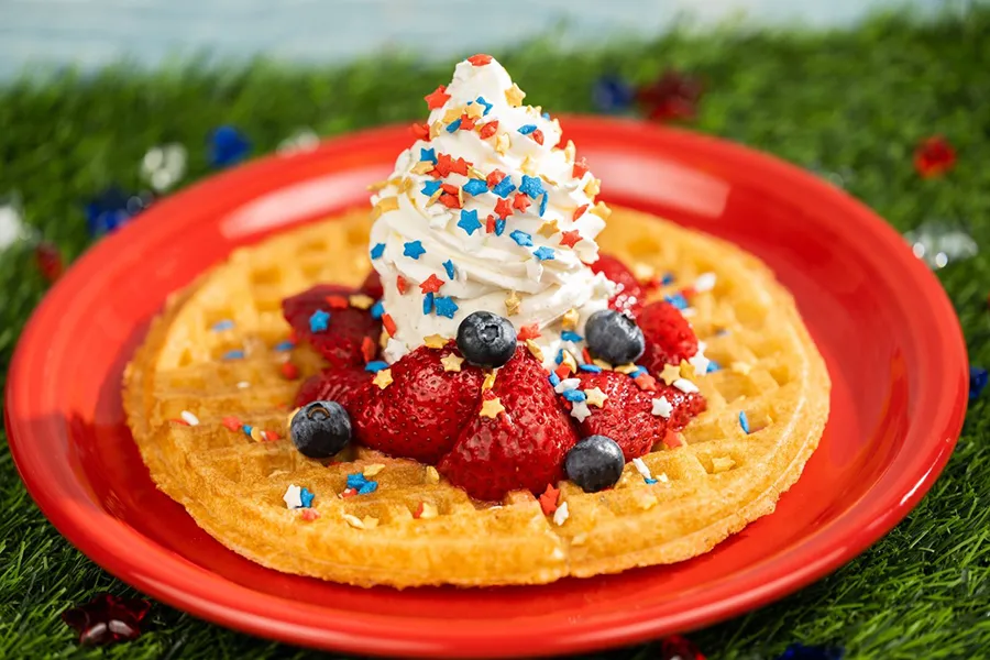 Waffle with red fruit, ice cream and granules in the colors of the American flag to celebrate the Fourth of July holiday at Walt Disney World