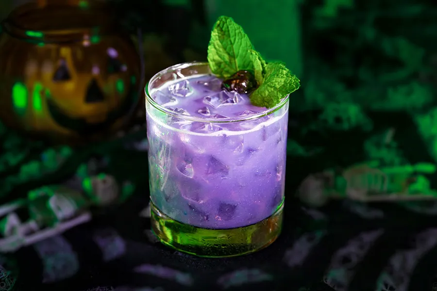 Drink Violet Specter is a feature of the Hallowen menu of Disney’s Cinderella’s Royal Table restaurant in 2025