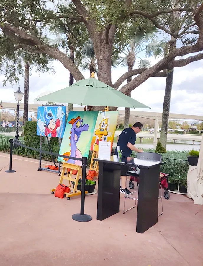 Artist exhibiting his works of art inspired by Disney characters at EPCOT's World Showcase