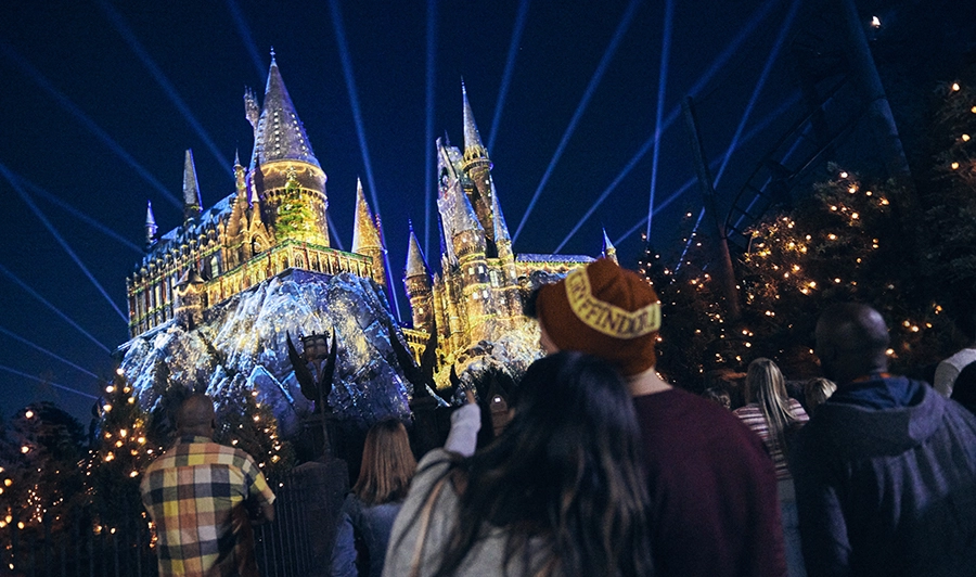 Casal assiste ao espetáculo noturno de projeção em frente ao castelo de Harry Potter na Universal Orlando Resort